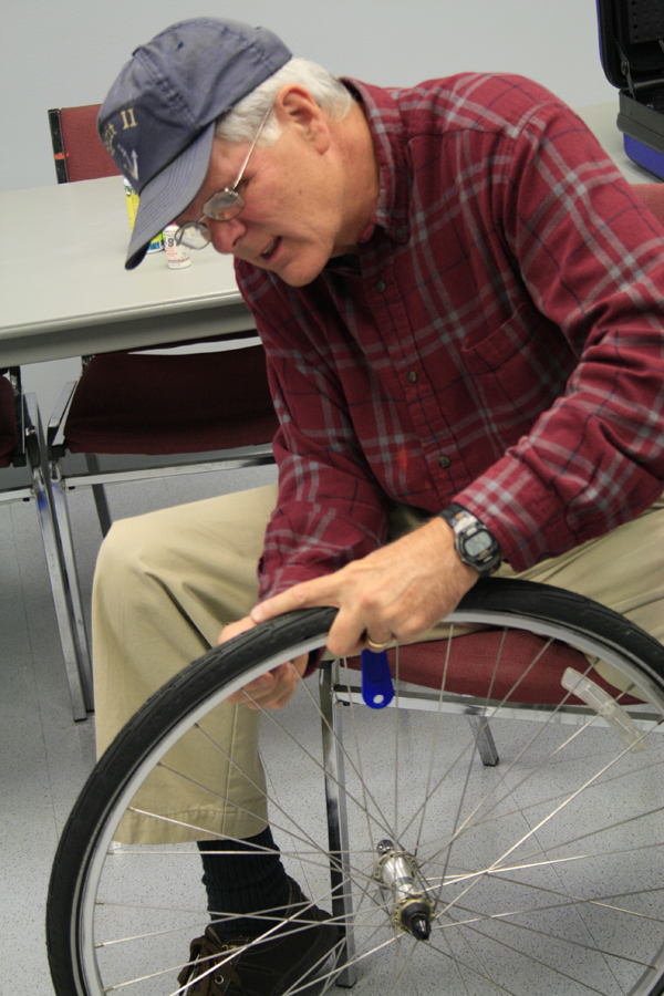 older adult working on a bike