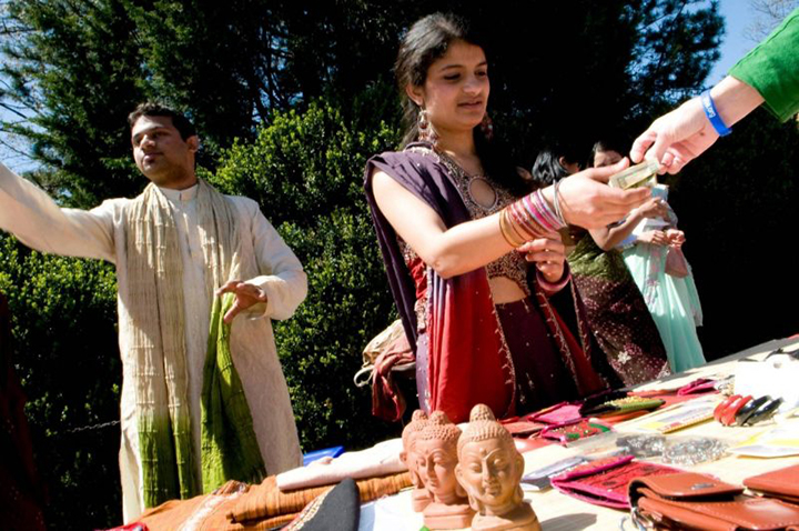 Students handing out items at the International Fair